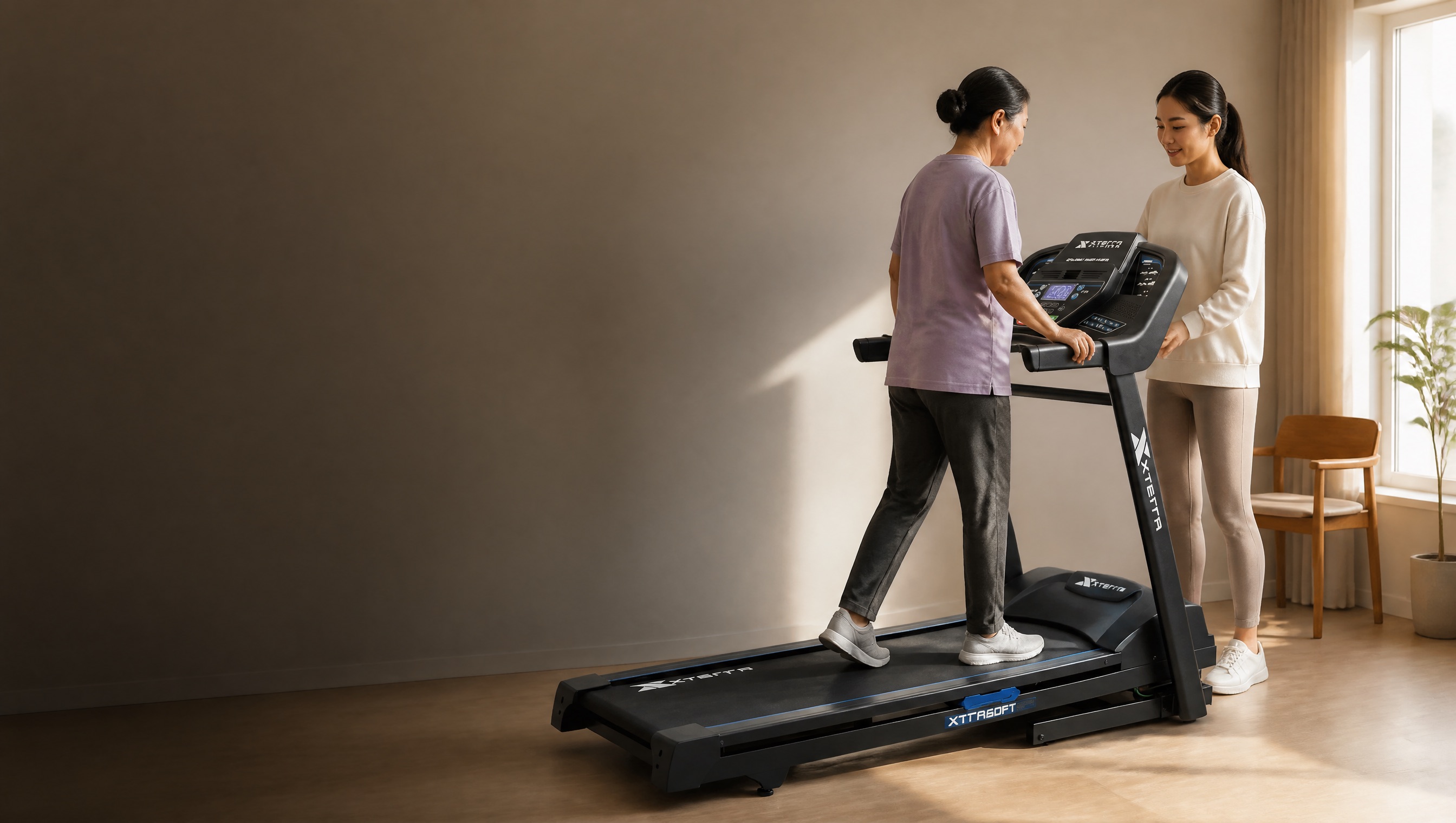 An adult daughter helping her mother begin a gentle home treadmill routine